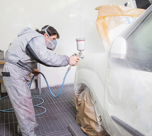 person painting a car